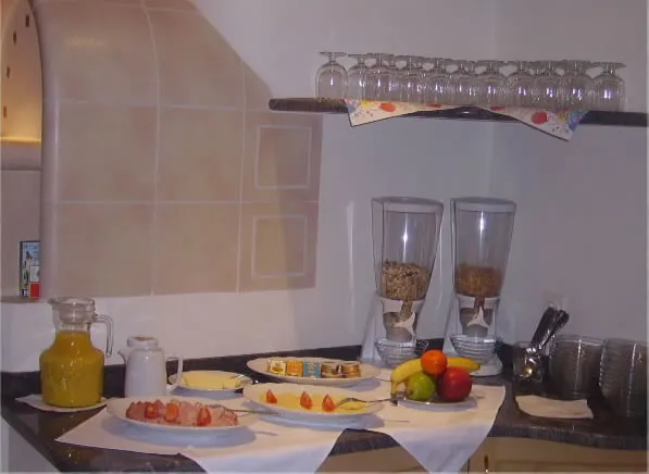 Breakfast table laid with juices and glasses